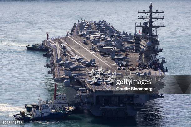 The USS Ronald Reagan, a Nimitz-class aircraft carrier and part of the US Navy 7th Fleet, approaches the naval base in Busan, South Korea, on Friday,...