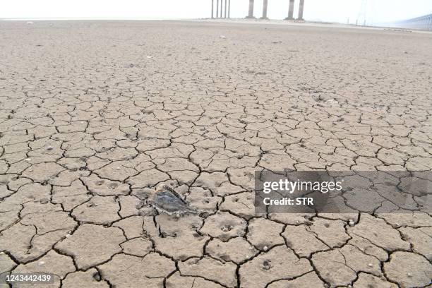 This photo taken on September 22, 2022 shows a dry area of China's largest freshwater Poyang Lake in Jiujiang in China's central Jiangxi province. /...