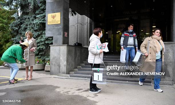 Election commission members with mobile ballot boxes leave the embassy of the self-proclaimed Donetsk People's Republic , the eastern Ukrainian...