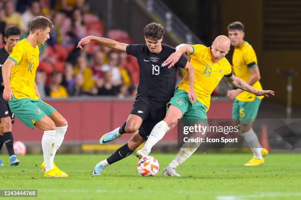 Aaron Mooy of Australia; Matthew Garbett of New Zealand during the International Friendly match Australia and New Zealand at Suncorp Stadium on...