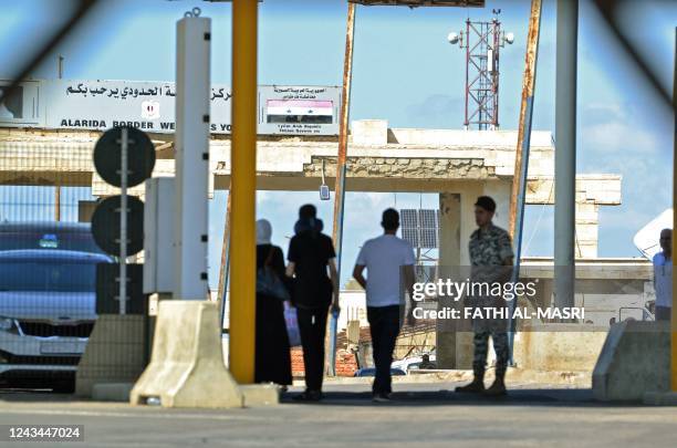 Relatives wait on the Lebanese side of the Arida Border Crossing with Syria on September 23 for the arrival of the bodies of the shipwrecked...