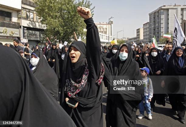 Iranians march during a pro-hijab rally in the capital Tehran on September 23, 2022. - Thousands of people marched through Iran's capital during a...
