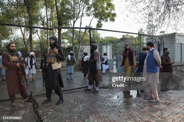 Taliban fighters investigate at a site after a blast near the Wazir Mohammad Akbar Khan Mosque that reportedly happened as people were leaving the...