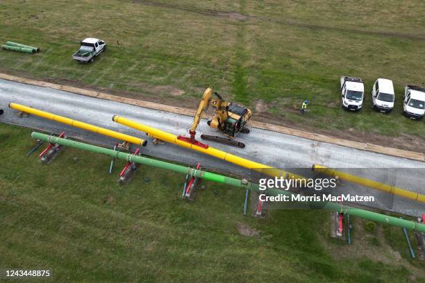 In an aerial view, pipeline pipes are offloaded at the construction site of a new liquified natural gas terminal on September 23, 2022 near...