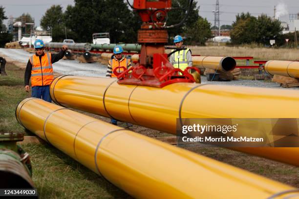 Pipeline pipes are offloaded at the construction site of a new liquified natural gas terminal on September 23, 2022 near Brunsbuettel, Germany. The...