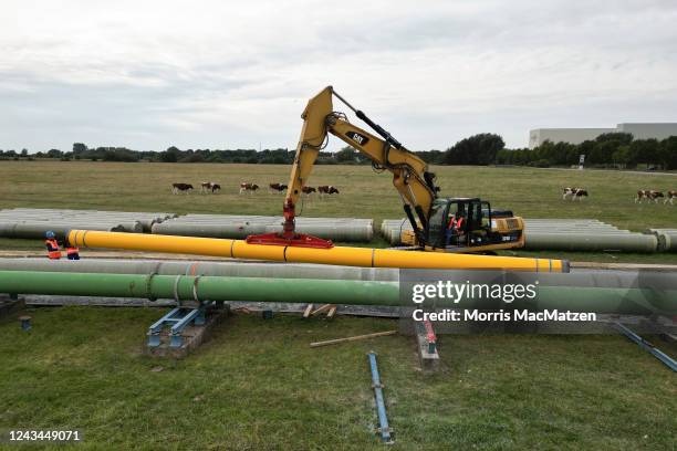 In an aerial view, pipeline pipes are offloaded at the construction site of a new liquified natural gas terminal on September 23, 2022 near...