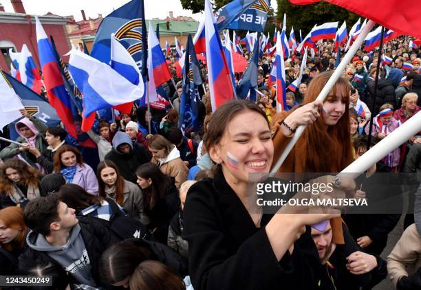 People attend a rally and a concert in support of annexation referendums in Russian-held regions of Ukraine, in Saint Petersburg on September 23,...