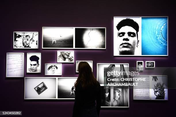 Visitor looks at artworks by artist Salih Basheer during a preview of the exhibition 'Habibi - Les revolutions de l'amour' at the Institut du Monde...