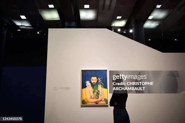 Visitor looks at artworks by artist Alireza Shojaian during a preview of the exhibition 'Habibi - Les revolutions de l'amour' at the Institut du...