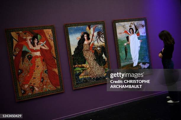 Visitor looks at artworks by artist Chaza Charafeddine during a preview of the exhibition 'Habibi - Les revolutions de l'amour' at the Institut du...