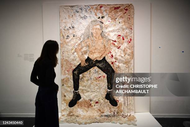 Visitor looks at artworks by Tunisian artist Aicha Snoussi during a preview of the exhibition 'Habibi - Les revolutions de l'amour' at the Institut...