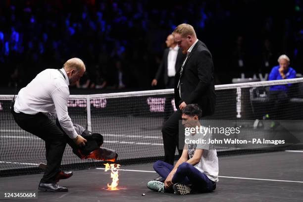 Protester lights a fire on the court on day one of the Laver Cup at the O2 Arena, London. Picture date: Friday September 23, 2022.