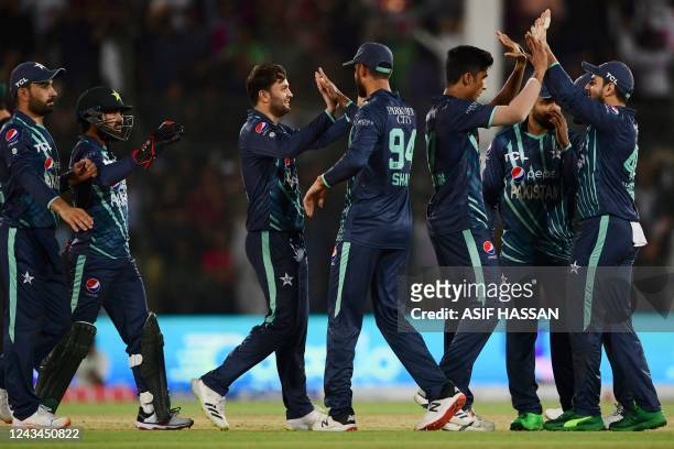 Pakistan's cricketers celebrate after the dismissal of England's Dawid Malan during the third Twenty20 international cricket match between Pakistan...