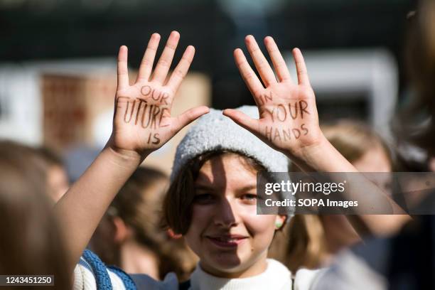 Girl with a slogan written on her hands is seen during the demonstration. Hundreds of kids, pupils and students took part in a march in Warsaw -...