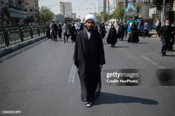 An Iranian cleric walks along the Enghelab avenue while arriving the University of Tehran to take part Friday prayers ceremonies before a...