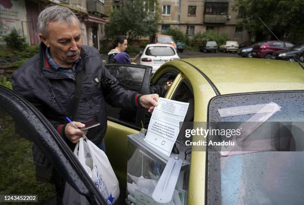 Residents cast their votes in controversial referendums in Donetsk Oblast, Ukraine on September 23, 2022. Voting will run from Friday to Tuesday in...