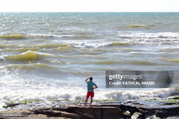 Lebanese man looks towards the sea near the Arida Border Crossing with Syria, on September 23 as relatives wait for the arrival of the bodies of...