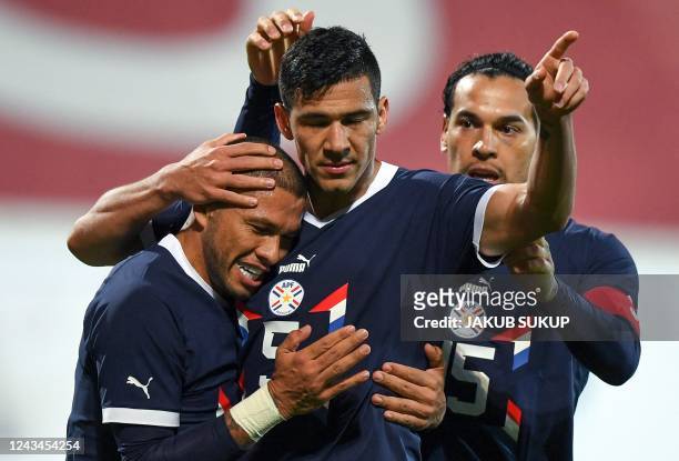 Paraguay's defender Fabian Balbuena celebrates scoring the opening goal with his teammates Paraguay's midfielder Richard Ortiz and Paraguay's...