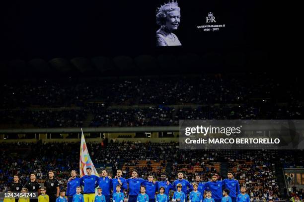 Portrait of late Queen Elizabeth II is displayed on the screen as Italy's players chant the national anthem during the UEFA Nations League's League A...