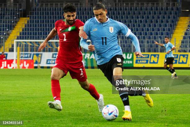 Iran's defender Sadegh Moharrami and Uruguay's forward Darwin Nunez vie for the ball during the friendly football match between Iran and Uruguay in...
