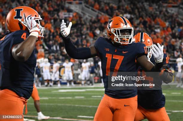Illinois outside linebacker Gabe Jacas celebrates with Illinois defensive end Jer'Zhan Newton after a quarterback sack during a college football game...