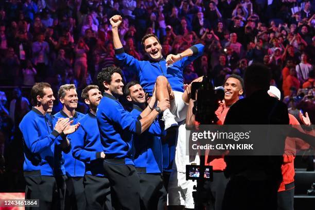 Switzerland's Roger Federer is given the bumps by teammates after playing his final match, a doubles with Spain's Rafael Nadal of Team Europe against...