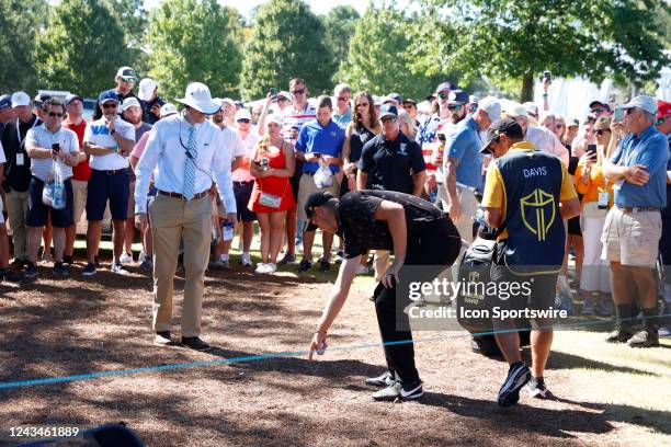 International Presidents Cup golfer Cam Davis looks to get a ruling of relief on his ball placement on the 13th hole during the 2022 Presidents Cup...