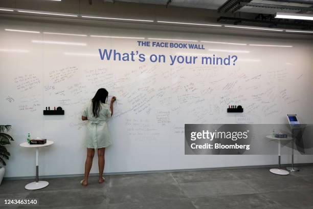 Woman writes on The Facebook Wall inside Meta Platforms Inc. India headquarters in Gurugram, India on Monday, June 20, 2022. Meta, which already...