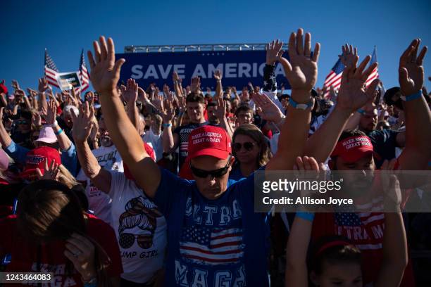 People pray before a Save America rally for former President Donald Trump at the Aero Center Wilmington on September 23, 2022 in Wilmington, North...