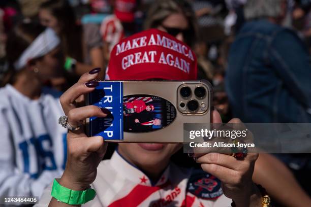 Woman takes a photo before a Save America rally for former President Donald Trump at the Aero Center Wilmington on September 23, 2022 in Wilmington,...