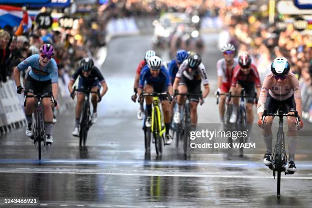 Belgian Lotte Kopecky ; Dutch Annemiek Van Vleuten crosses the finish line of the elite women road race at the UCI Road World Championships Cycling...