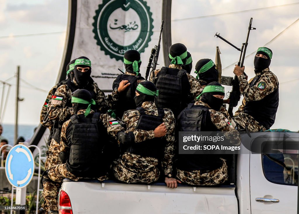 Members of the Izz al-Din al-Qassam Brigades, the military...