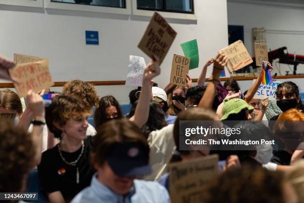 Students hold signs during a Fairfax County School Board meeting after a rally in support of inclusive Family Life Education at Luther Jackson Middle...