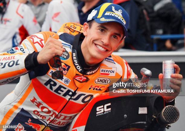 Repsol Honda Team rider Marc Marquez of Spain celebrates his pole position at the parc ferme during the MotoGP class qualifying of MotoGP Japanese...