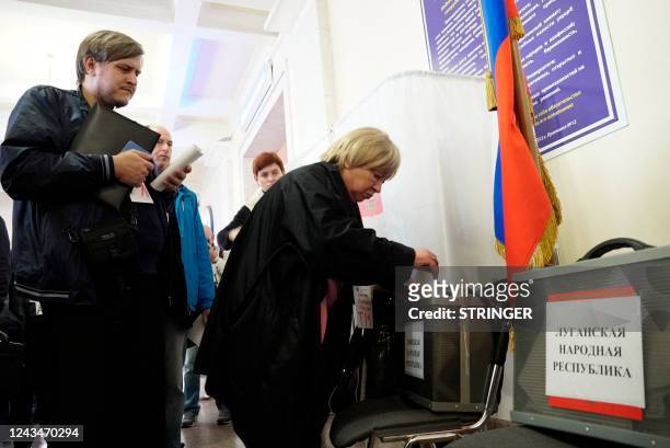 Refugee from Ukraine regions held by Russia casts a ballot for a referendum at a polling station in Rostov-on-Don on September 24, 2022. - The voting...