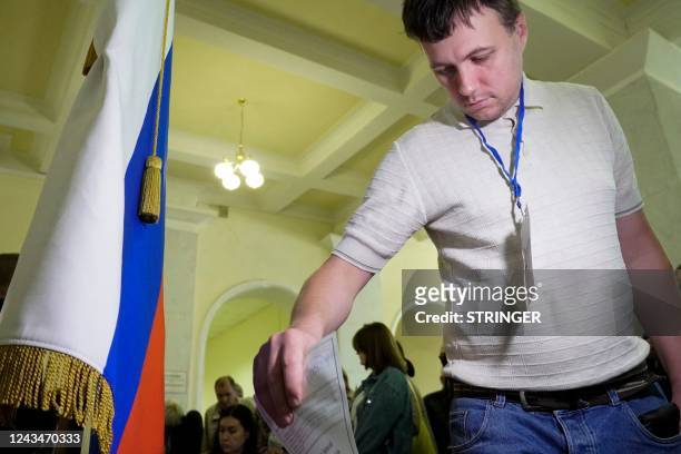 Refugee from Ukraine regions held by Russia casts a ballot for a referendum at a polling station in Rostov-on-Don on September 24, 2022. - The voting...