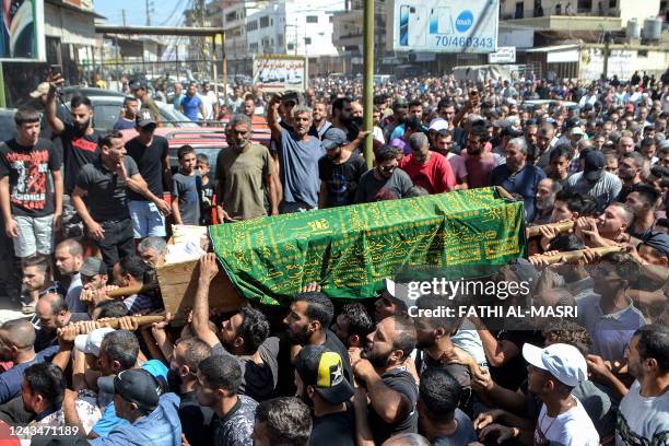 Mourners march with the body of one of the victims who drowned in the shipwreck of a migrant boat that sank off the Syrian coast, during his funeral...