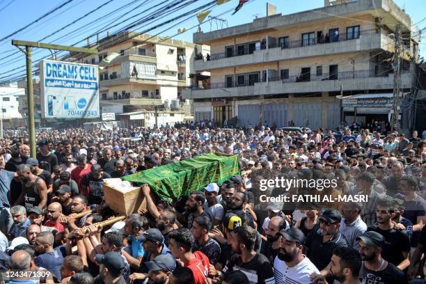 Mourners march with the body of one of the victims who drowned in the shipwreck of a migrant boat that sank off the Syrian coast, during his funeral...