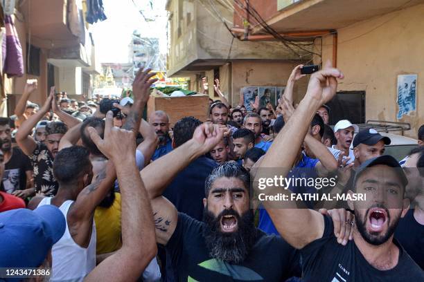 Mourners chant slogans as they marc with the body of one of the victims who drowned in the shipwreck of a migrant boat that sank off the Syrian...