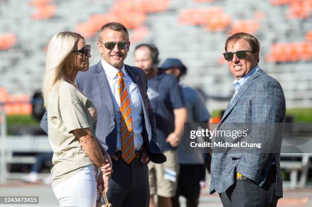 Head coach Bryan Harsin of the Auburn Tigers speaks with his wife Kes Harsin and head coach Eliah Drinkwitz of the Missouri Tigers prior to their...