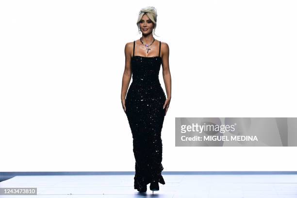Media personality Kim Kardashian presents a creation for Dolce & Gabbana's Women's Spring Summer 2023 fashion collection on September 24, 2022 as...