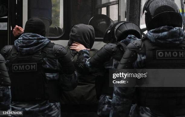 Police officers detain a man in Moscow on September 24 following calls to protest against the partial mobilisation announced by the Russian...