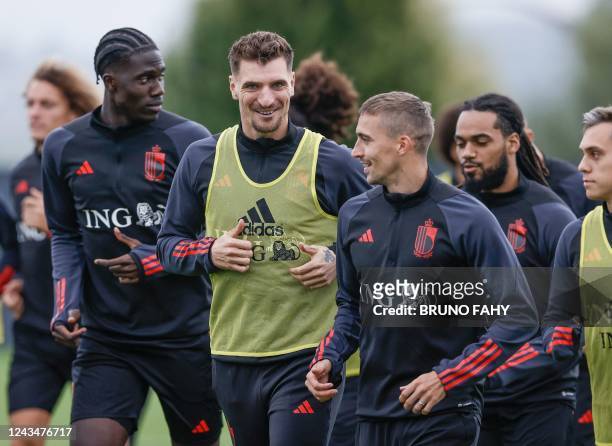 Belgium's national football team players Amadou Onana, Thomas Meunier and Timothy Castagne attend a training session on September 24, 2022 in Tubize,...