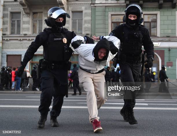 Police officers detain a man in Saint Petersburg on September 24 following calls to protest against the partial mobilisation announced by the Russian...