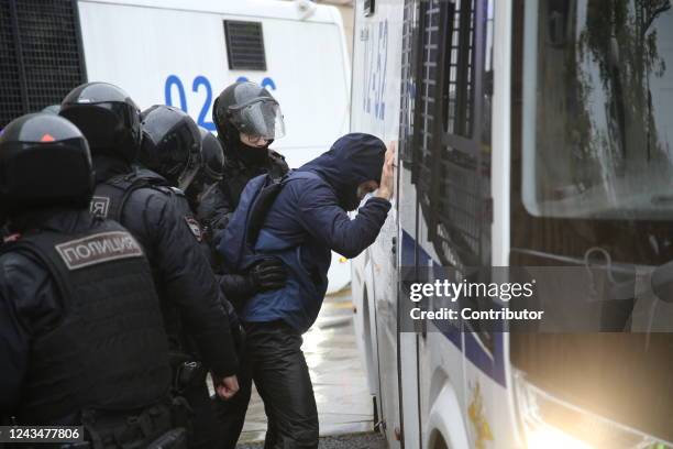 Police officers searches a detained protester during the unsanctioned rally hosted by the Vesna Movement in protest against the military invasion on...