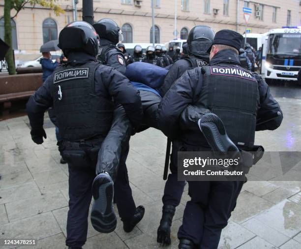 Police officers detain a protester during the unsanctioned rally hosted by the Vesna Movement in protest against the military invasion on Ukraine and...