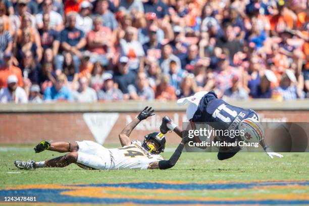 Defensive back Kris Abrams-Draine of the Missouri Tigers tackles wide receiver Shedrick Jackson of the Auburn Tigers during the first half of play at...