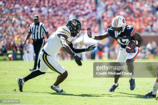 Wide receiver Camden Brown of the Auburn Tigers looks to run the ball by defensive back Jaylon Carlies of the Missouri Tigers during the first half...