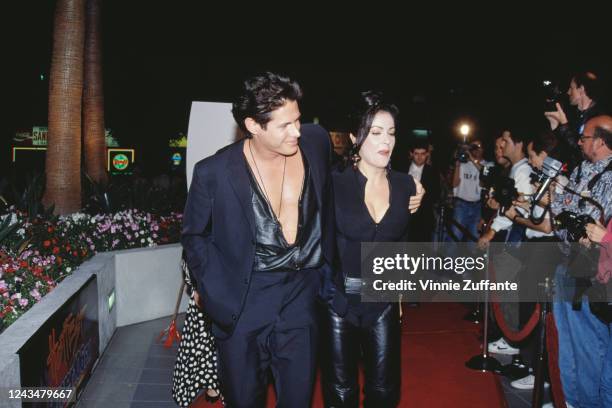 American actor and screenwriter Kevin Bernhardt and his wife, American singer and actress Apollonia Kotero attend the premiere of 'Hellraiser III:...