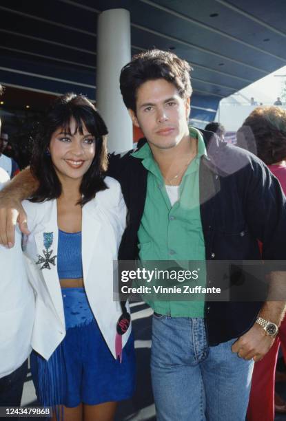 American singer and actress Apollonia Kotero and American actor and screenwriter Kevin Bernhardt attend the premiere of 'Captain EO' at the Epcot...